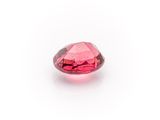 a close up of a pink diamond on a white surface
