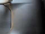 a seat in the back of a car with a steering wheel