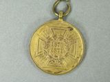 a gold medal with a picture of a lion on it