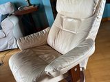 a reclining chair in a living room with blue walls