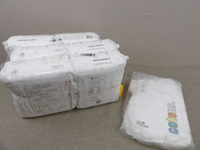 a lot of bags of toilet paper sitting on a table