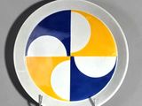yellow, blue, and white plate with a circular design on it