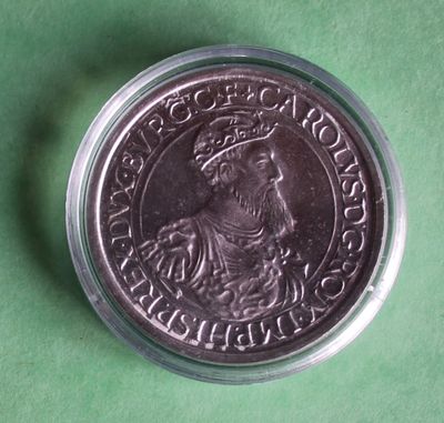 a close up of a coin on a green surface