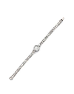 a close up of a watch on a white surface with a white background