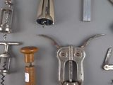 many different types of wine openers on the wall