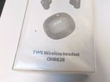 a box of wireless headset on a table next to a laptop