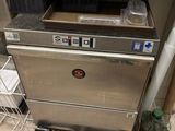 a silver dishwasher sitting on a counter in a kitchen