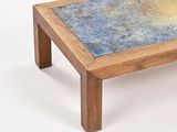a small wooden table with a blue and yellow design on it
