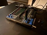 a table with a mixer and a remote control on it