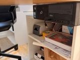a desk with a printer and a bag on top of it