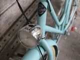 a blue bicycle parked on the side of the street