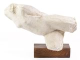 a sculpture of a person laying down on a wooden base