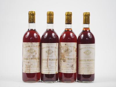 trois bouteilles de vin posées les unes à côté des autres sur une surface blanche