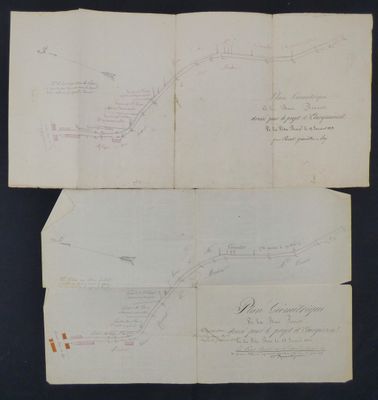 two pages of paper with drawings on them on a black surface