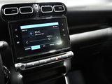 the interior of a car with a touch screen and steering controls