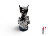a black and white cat figurine sitting on top of a table