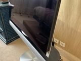 a flat screen tv sitting on a stand in a living room