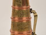 a copper pitcher with a handle on a white background
