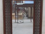 a mirror that is sitting on the ground in front of a wall