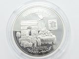 the coin is in a clear plastic container on a white surface