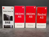 three redmi a5s are sitting next to each other on a table