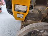a close up of a yellow and black machine on the ground