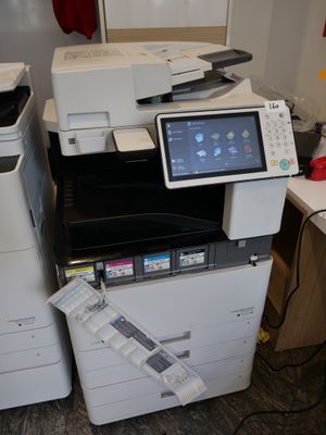 many printers and scanners sitting on a desk