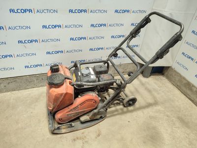 a close up of a small lawn mower on a concrete floor
