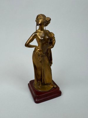 bronze statue of a woman holding a basket of flowers on a wooden base