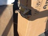 a box that is sitting on the ground next to a trash can
