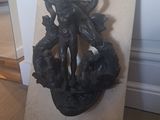 a statue of a woman holding a fish on a plaque