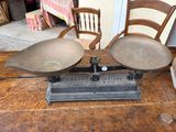 two chairs and a table with a scale on it