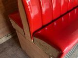 a red bench that is sitting in a room