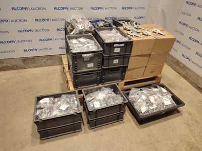 several boxes of assorted items sit on a pallet in front of a wall