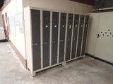several lockers are lined up in a room with a door open