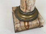 a marble column with a metal base on a white background