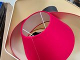 a pink lamp that is on top of a cardboard box