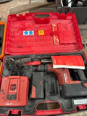 a red tool box with tools in it sitting on a table