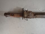 a very old knife that is laying on the floor