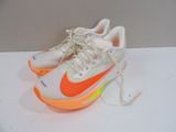 pair of white and orange nike sneakers on a white surface