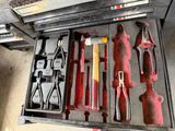 many tools in a tool box on the floor