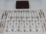a lot of silverware on a table with a wooden box