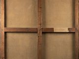 an old wooden easel with a piece of paper on top of it