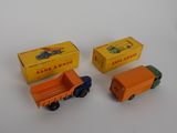 three toy trucks sitting next to each other on a table