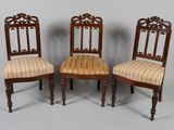 three chairs with striped upholstered seats and a wooden frame