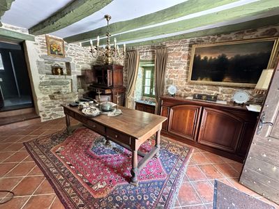 a living room with a table and a rug on the floor