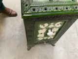 someone is standing next to a green box with a drawer on top of it