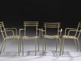 three chairs and a table in a room with a black background