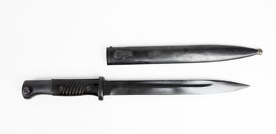 two knives that are laying side by side on a white surface