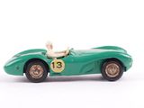 a green toy car with a man sitting in it